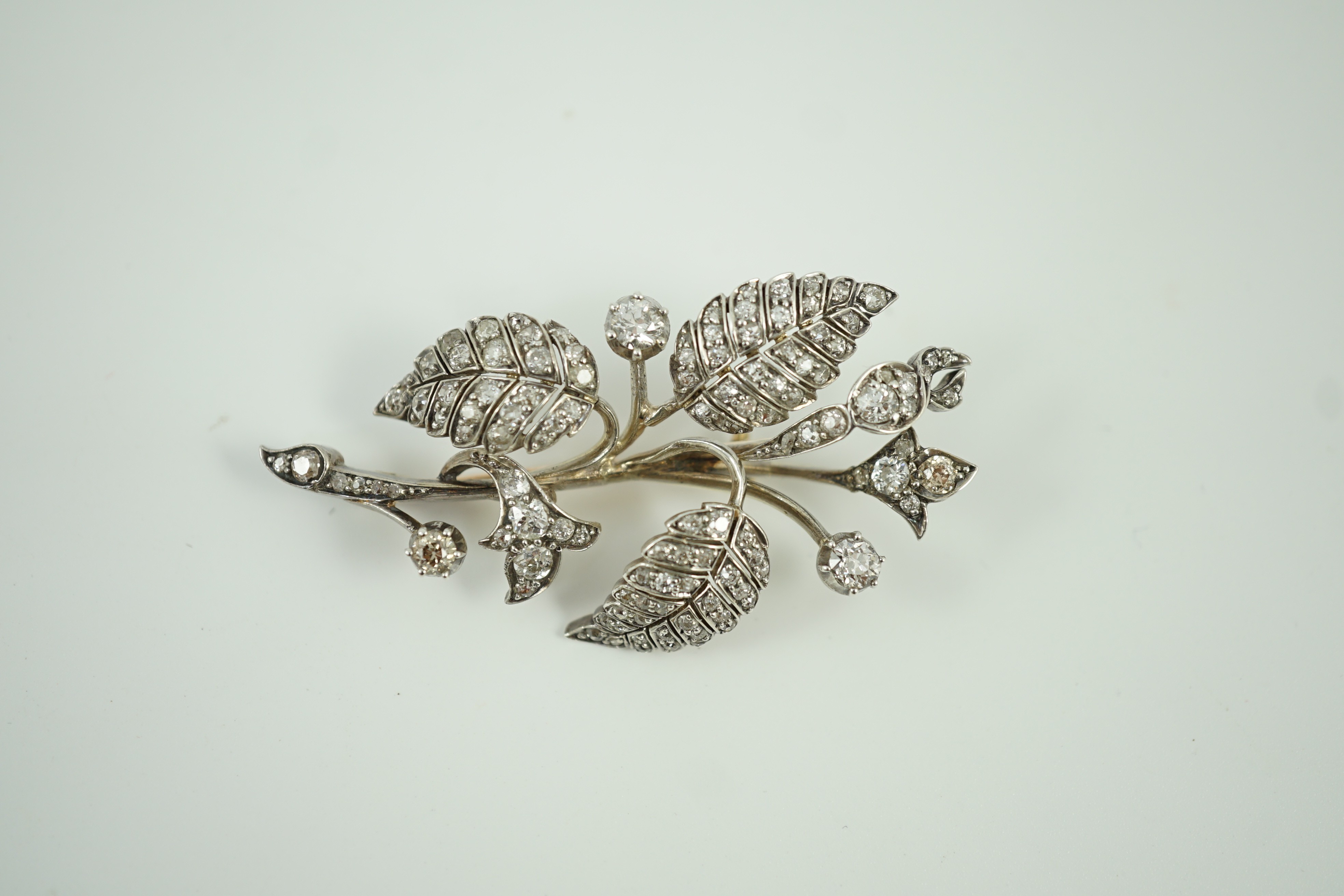 A mid 20th century yellow and white metal, diamond cluster set floral spray brooch, 61mm, gross weight 15.5 grams.